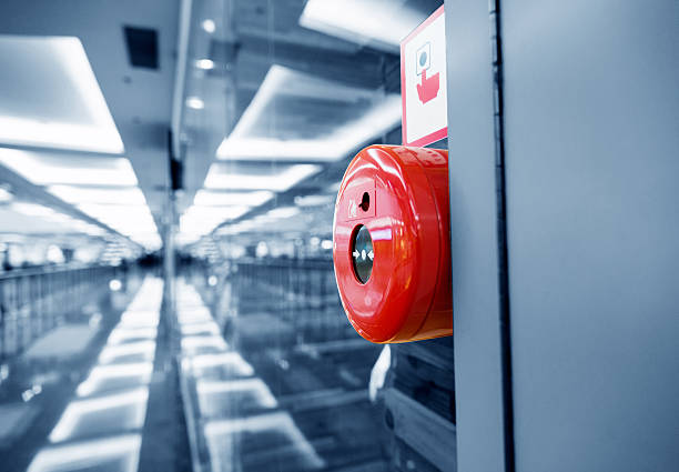 Fire alarm button on wall of shopping center.